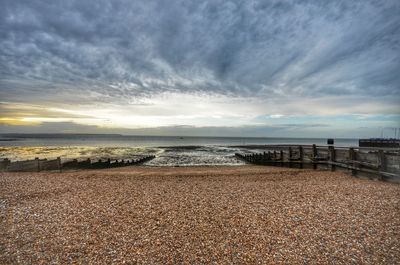 Scenic view of beach against sky during sunset