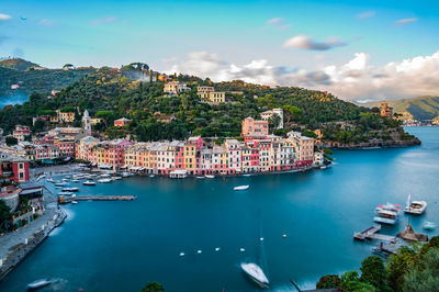 High angle view of townscape by sea against sky