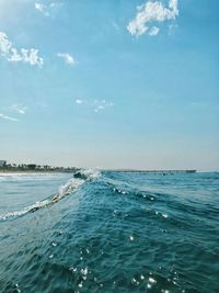 Scenic view of sea against blue sky