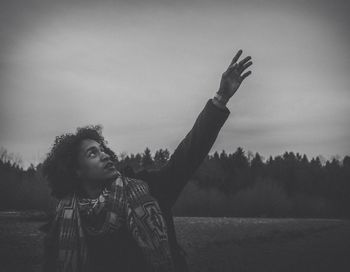 Man standing on field against sky