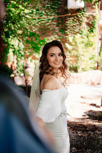 Portrait of smiling woman standing outdoors