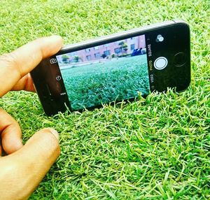 Cropped image of person standing on grassy field