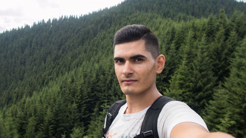 Portrait of young man in forest