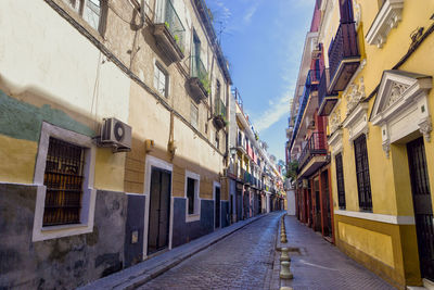 Street amidst buildings against sky