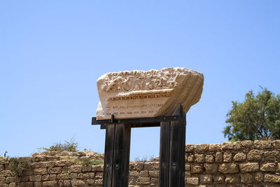 Low angle view of old ruin against clear blue sky