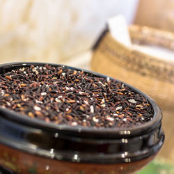 Close-up of uncooked black rice in ceramic bowl