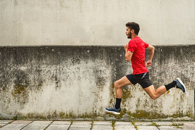 Young man running fast in the park