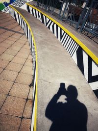 Shadow of person on bridge