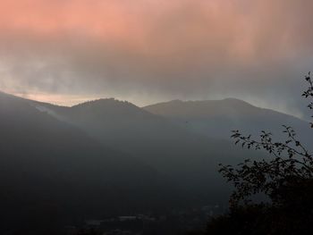 Scenic view of silhouette mountains against sky at sunset