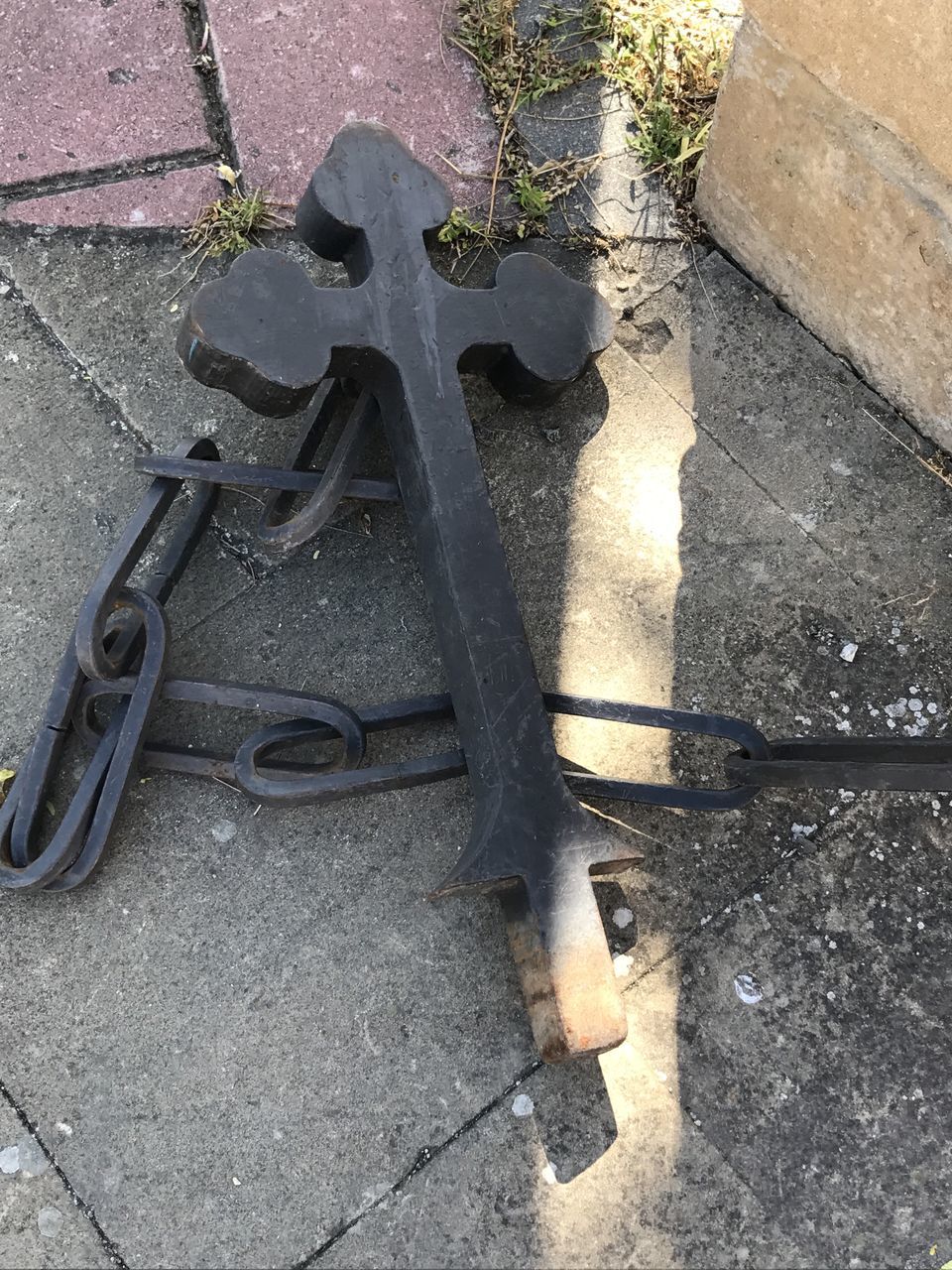 HIGH ANGLE VIEW OF OLD METAL ON FOOTPATH