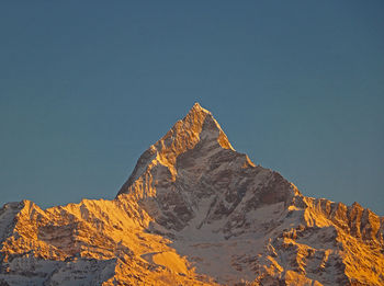 Low angle view of machapuchare mountain against sky 