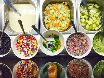 Directly above shot of various sweet foods and fruits in shop