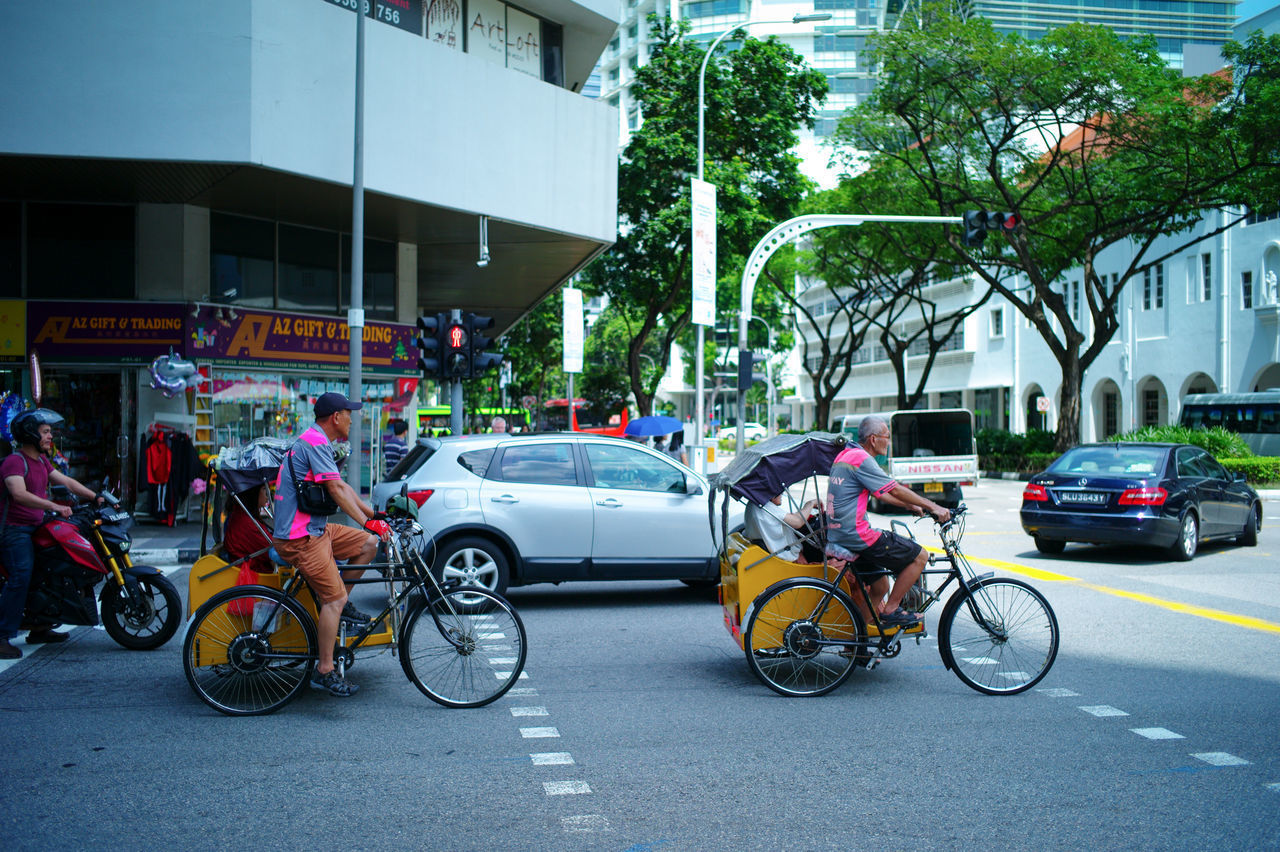 PEOPLE RIDING MOTORCYCLE ON ROAD