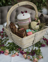 High angle view of easter basket with flowers on table