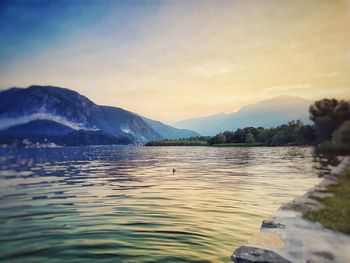 Scenic view of lake against sky during sunset