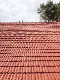 Red roof tiles against sky