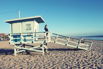 Lifeguard hut on beach against clear sky