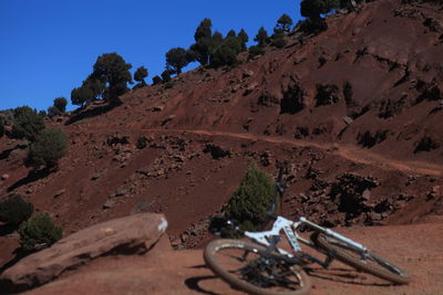 Bicycle on field against mountain