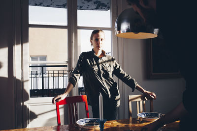 Man standing on table at home