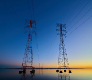 High voltage transmission lines crossing wheeler lake at dusk near athens al. 