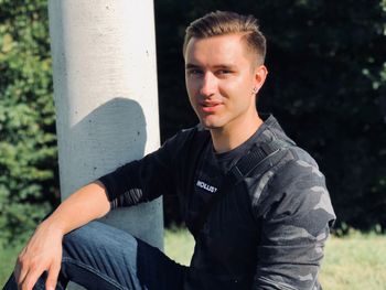 Portrait of young man sitting outdoors