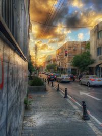 City street against sky during sunset