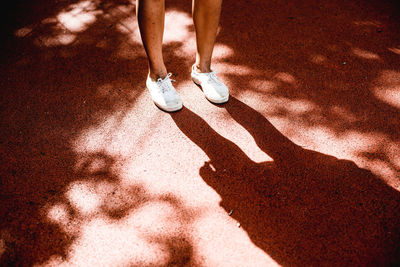 Low section of man standing on footpath