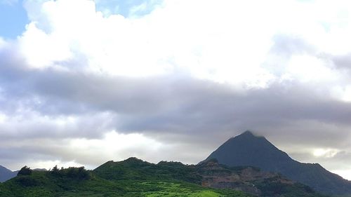 Scenic view of mountains against cloudy sky