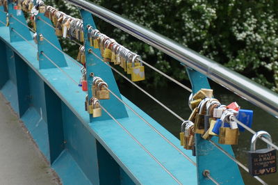 Padlocks on a bridge, spanning a river. 