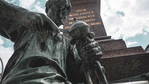 Low angle view of statue against sky