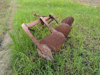 Old rusty wheel on field