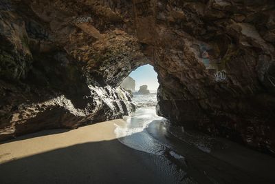 Scenic view of sea seen through cave