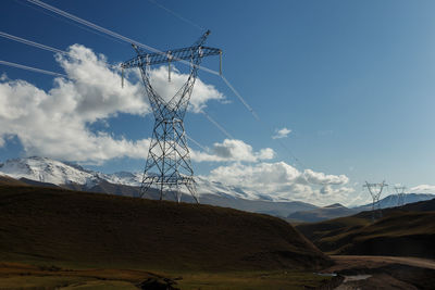 Low angle view of electricity pylon against sky