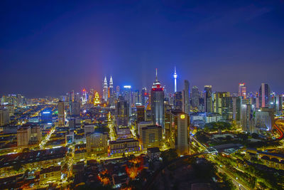 Aerial view of city lit up at night