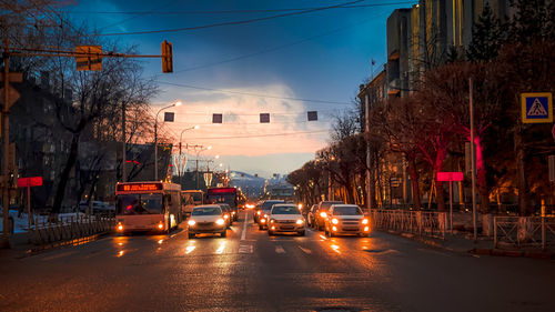 Cars on road in city at dusk