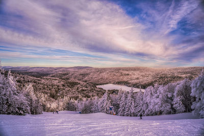 Scenic view of snowcapped landscape against sky during winter