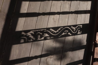 Close-up of text on wooden wall