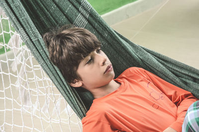 Portrait of young woman sitting on hammock