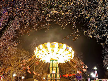 Low angle view of illuminated ferris wheel at night