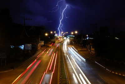 Light trails on road in city at night