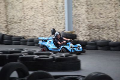 Teenage boy driving go-cart