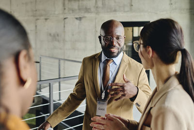 Businessman talking with colleague at convention center