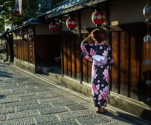 Rear view of woman walking on street