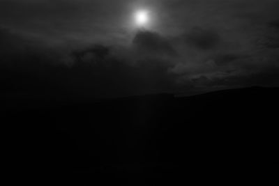 Low angle view of silhouette landscape against sky at night