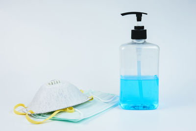 Close-up of drinking glass on table against white background