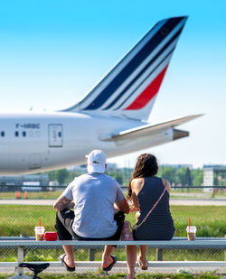 Rear view of couple against clear sky