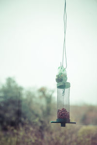 Close-up of lamp hanging against clear sky