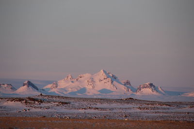 Scenic view of snowcapped mountains against sky during sunset