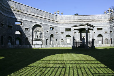 Built structure against sky with lawn in foreground