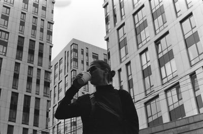 Low angle view of man standing against building